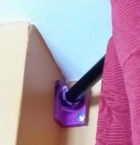 Rod holder for corner wall